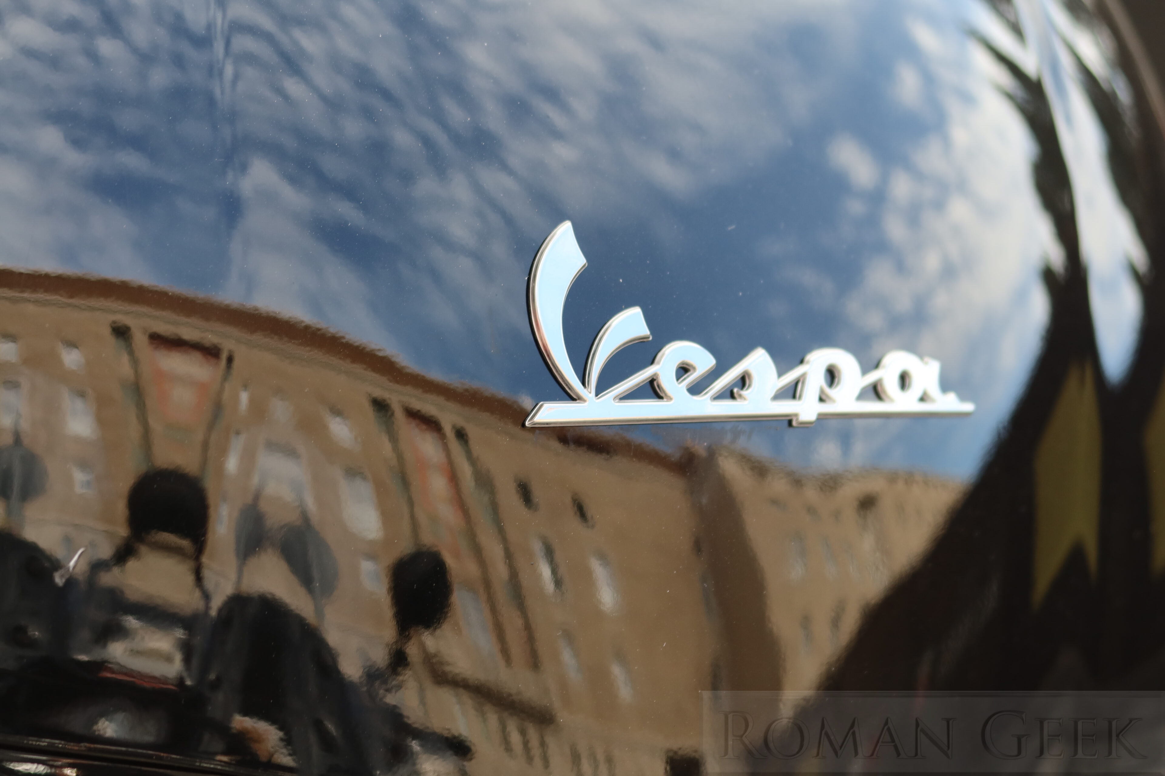 Reflection on a Vespa moped, Rome